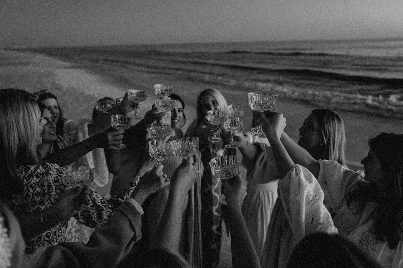 Two women celebrating at night on a beach — Studio Hevesi editorial lifestyle photography